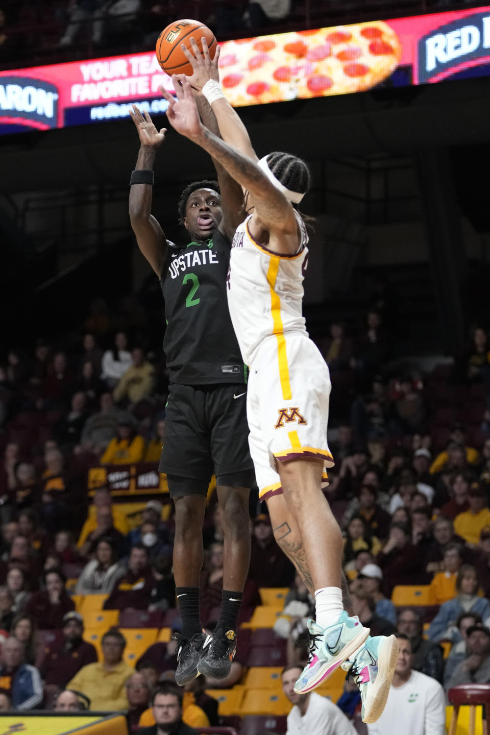 USC Upstate guard Justin Bailey (2) takes a shot as Minnesota guard Braeden Carrington defends during the second half of an NCAA college basketball game, Saturday, Nov. 18, 2023, in Minneapolis. (AP Photo/Abbie Parr)