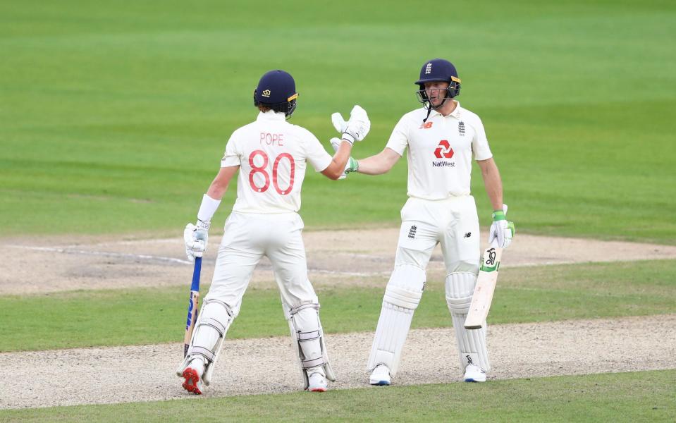 Jos Buttler of England(R) celebrates after reaching his half century with Ollie Pope of England during Day One of the Ruth Strauss Foundation Test - GETTY IMAGES