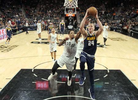 Dec 26, 2018; San Antonio, TX, USA; Denver Nuggets power forward Mason Plumlee (24) is fouled by San Antonio Spurs shooting guard DeMar DeRozan (10) while going up for a shot during the second half at AT&T Center. Mandatory Credit: Soobum Im-USA TODAY Sports