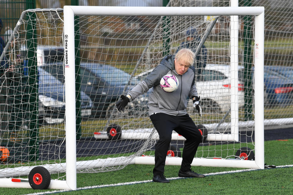 Prime Minister Boris Johnson tries his hand in goal before a football match between Hazel Grove Utd and Poynton Jnr u10s in the Cheshire Girls football league in Cheadle Hume, Cheshire, while on the election campaign trail.