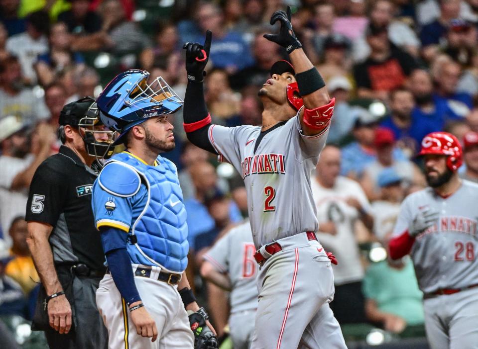 Aug 6, 2022; Milwaukee, Wisconsin, USA; Cincinnati Reds shortstop Jose Barrero (2) reacts after hitting a solo home run in the sixth inning as Milwaukee Brewers catcher Victor Caratini (7) looks on at American Family Field. Mandatory Credit: Benny Sieu-USA TODAY Sports