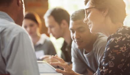 Business people sharing digital tablet in meeting