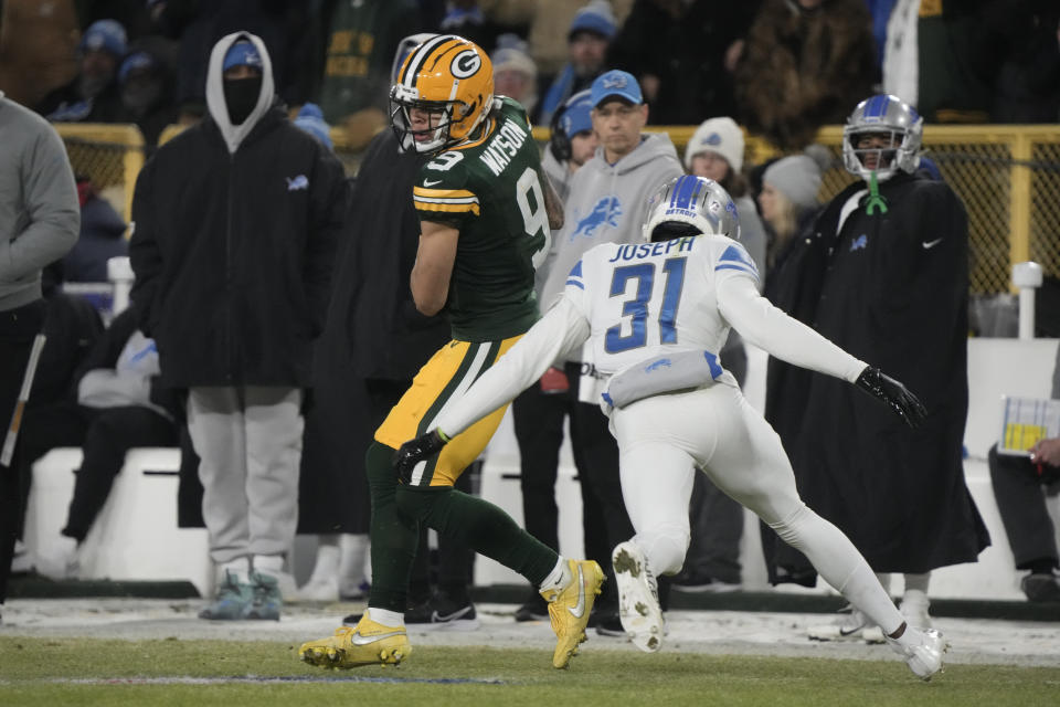 Green Bay Packers wide receiver Christian Watson (9) catches a pass as Detroit Lions safety Kerby Joseph (31) defends during the first half of an NFL football game Sunday, Jan. 8, 2023, in Green Bay, Wis. (AP Photo/Morry Gash)