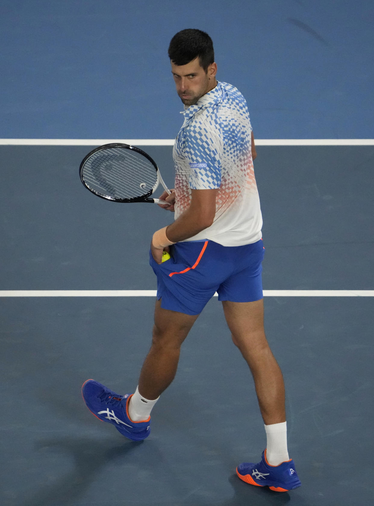 Novak Djokovic of Serbia reacts while playing against Stefanos Tsitsipas of Greece during the men's singles final at the Australian Open tennis championships in Melbourne, Australia, Sunday, Jan. 29, 2023. (AP Photo/Ng Han Guan)