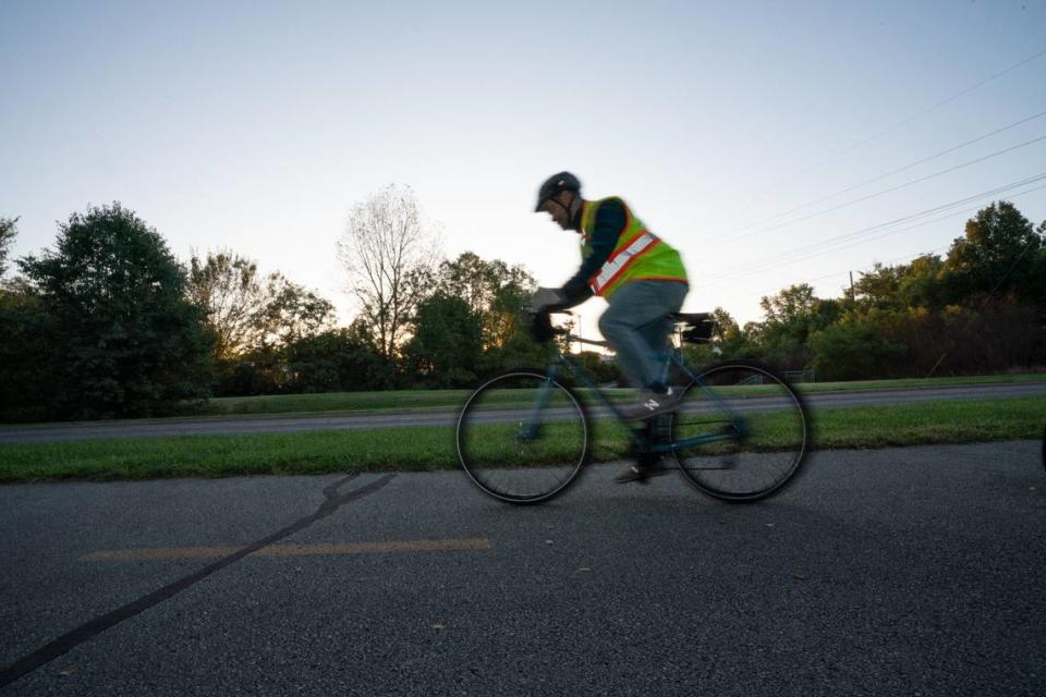 Jeff Manuel rides a bicycle in Edwardsville, Ill. on Oct. 6, 2023 as the leader of a “bike bus,” where two adults serve as the fore and vanguard to a train of children bicycling to school.