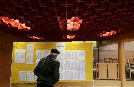 A voter checks the list of candidates before casting his ballot at a polling station during the country's parliamentary election in the village of Ruzindol, Slovakia, March 5, 2016. REUTERS/David W Cerny