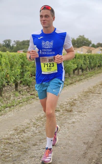 Writer Alex Barton passes by a vineyard during the Marathon du Medoc