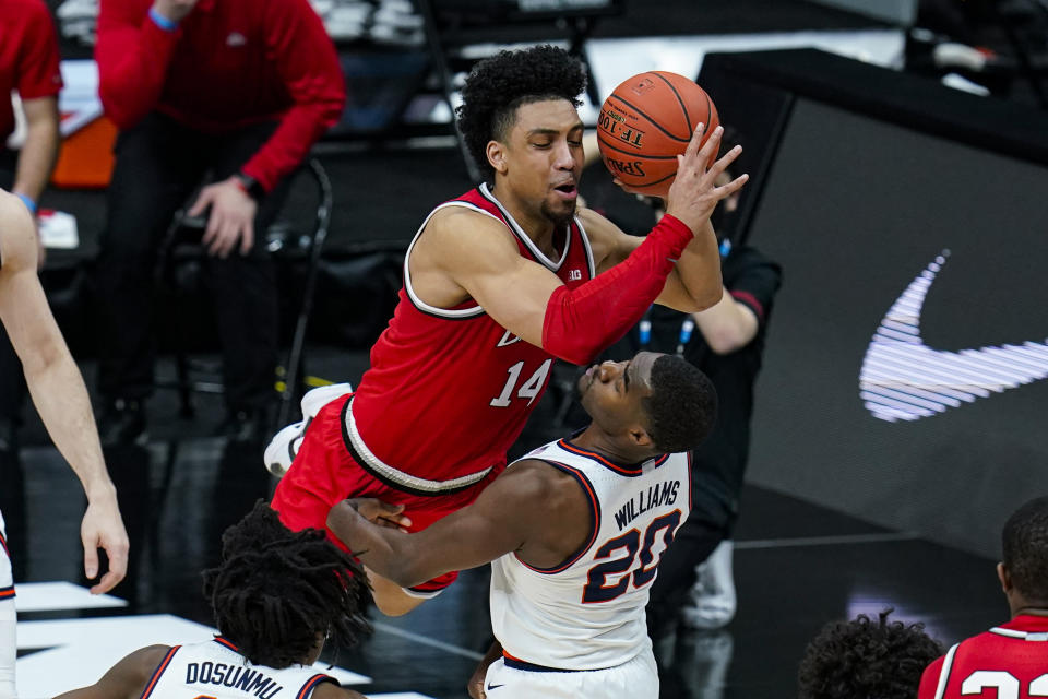 Ohio State forward Justice Sueing (14) draws the foul from Illinois guard Da'Monte Williams (20) during the second half of an NCAA college basketball championship game at the Big Ten Conference tournament, Sunday, March 14, 2021, in Indianapolis. (AP Photo/Michael Conroy)