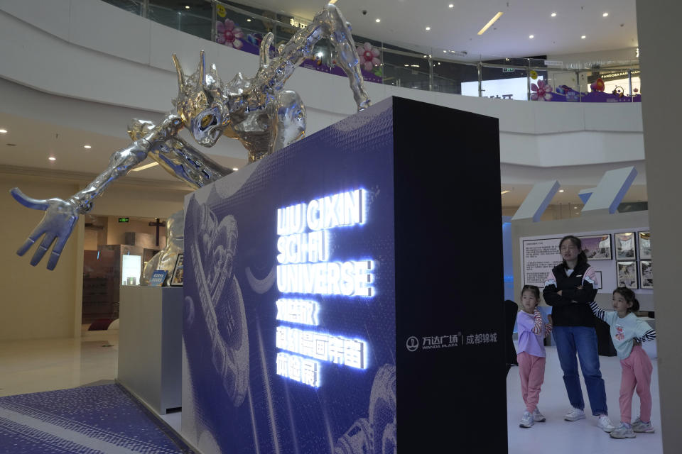 Visitors look at an exhibition depicting the science fiction universe from a trilogy by Chinese author Liu Cixin in Chengdu, Sichuan province on Saturday, Oct. 21, 2023. The series that began with "The Three-Body Problem" helped Chinese science fiction break through internationally, winning awards and making it onto the reading lists of the likes of former U.S. President Barack Obama and Mark Zuckerberg. (AP Photo/Ng Han Guan)