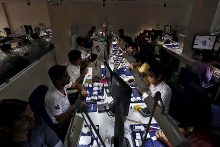 FILE PHOTO: Craftsmen work at the polishing department of a diamond processing unit at Surat in Gujarat, India, August 31, 2015. REUTERS/Amit Dave/File Photo