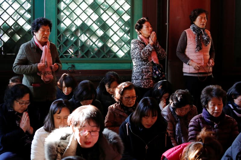 Parents pray for their children's success in the college entrance examinations at a Buddhist temple in Seoul