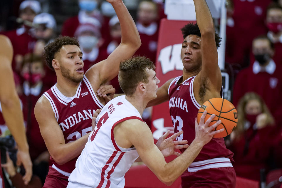 Wisconsin's Tyler Wahl (5) works against Indiana's Race Thompson, left, and Trayce Jackson-Davis during the first half of an NCAA college basketball game Wednesday, Dec. 8, 2021, in Madison, Wis. (AP Photo/Andy Manis)