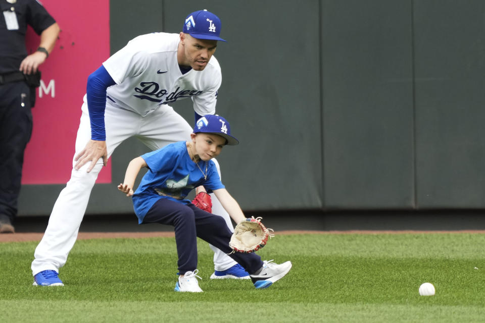 National League's Freddie Freeman, of the Los Angeles Dodgers, fields balls with a boy wearing his jersey number during batting practice before the MLB All-Star baseball Home Run Derby in Seattle, Monday, July 10, 2023. (AP Photo/Ted Warren)