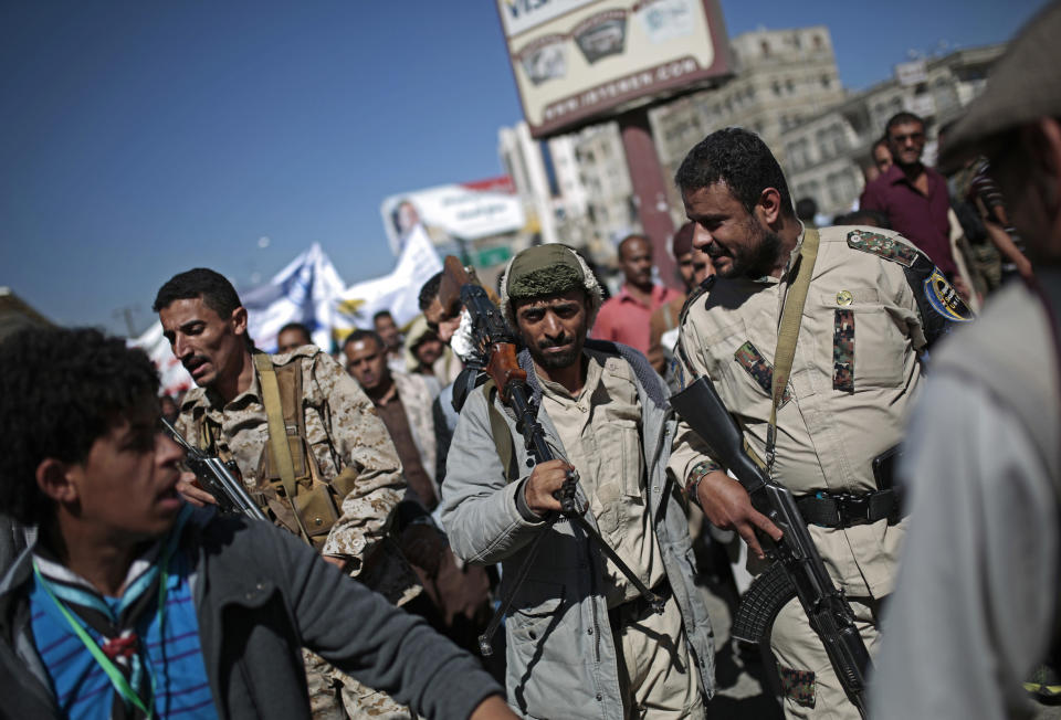 FILE - In this Monday, Dec. 10, 2018 file photo, Houthi fighters take part in a protest calling for the reopening of Sanaa airport to receive medical aid, in front of the U.N. offices in Sanaa, Yemen. The United Arab Emirates, one of the most powerful parties in Yemen’s war, has begun to draw down its forces in past weeks in 2019, leaving the Saudi-led coalition with a weakened ground presence and fewer tactical options. (AP Photo/Hani Mohammed, File)