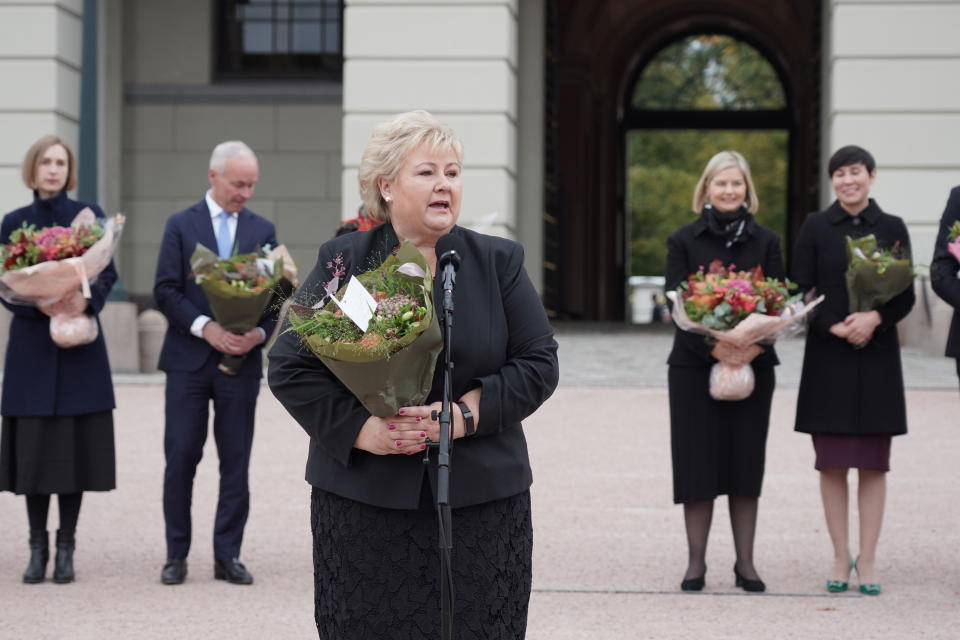 Norway's Prime Minister Erna Solberg with her outgoing government speaks outside the Royal Palace in Oslo, Thursday Oct. 14, 2021. Norway's Conservative Prime Minister Erna Solberg will step down as head of a three-party, minority center-right government after the left-leaning bloc won last month’s parliament election. (Ole Berg-Rusten/NTB via AP)