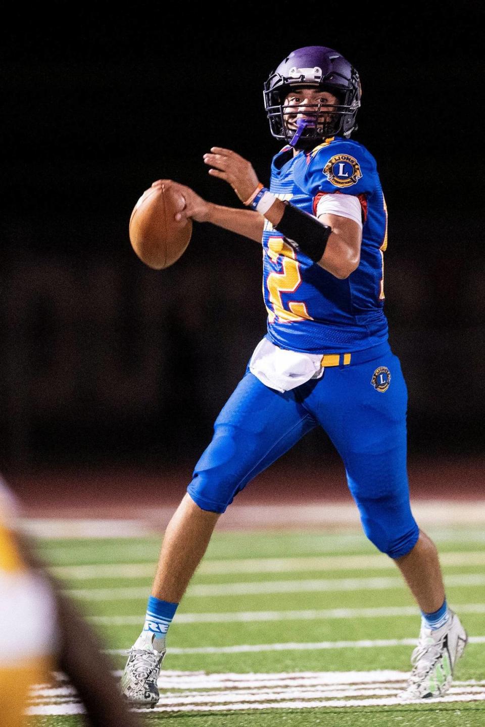 North All-Star quarterback representing Orestimba, Alex Millan (12) rolls out of the pocket to pass during the Merced County All-Star Football Game at Golden Valley High School in Merced, Calif., on Saturday, June 15, 2024. The South All-Stars beat the North All-Stars 33-20.