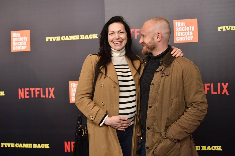 Laura Prepon, with Ben Foster, cradles her baby bump at the premiere for the documentary series "Five Came Back" on March 27, 2017 in New York City.