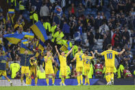 The Ukrainian team celebrate at the final whistle of the World Cup 2022 qualifying play-off soccer match between Scotland and Ukraine at Hampden Park stadium in Glasgow, Scotland, Wednesday, June 1, 2022. (Malcolm Mackenzie/PA via AP)