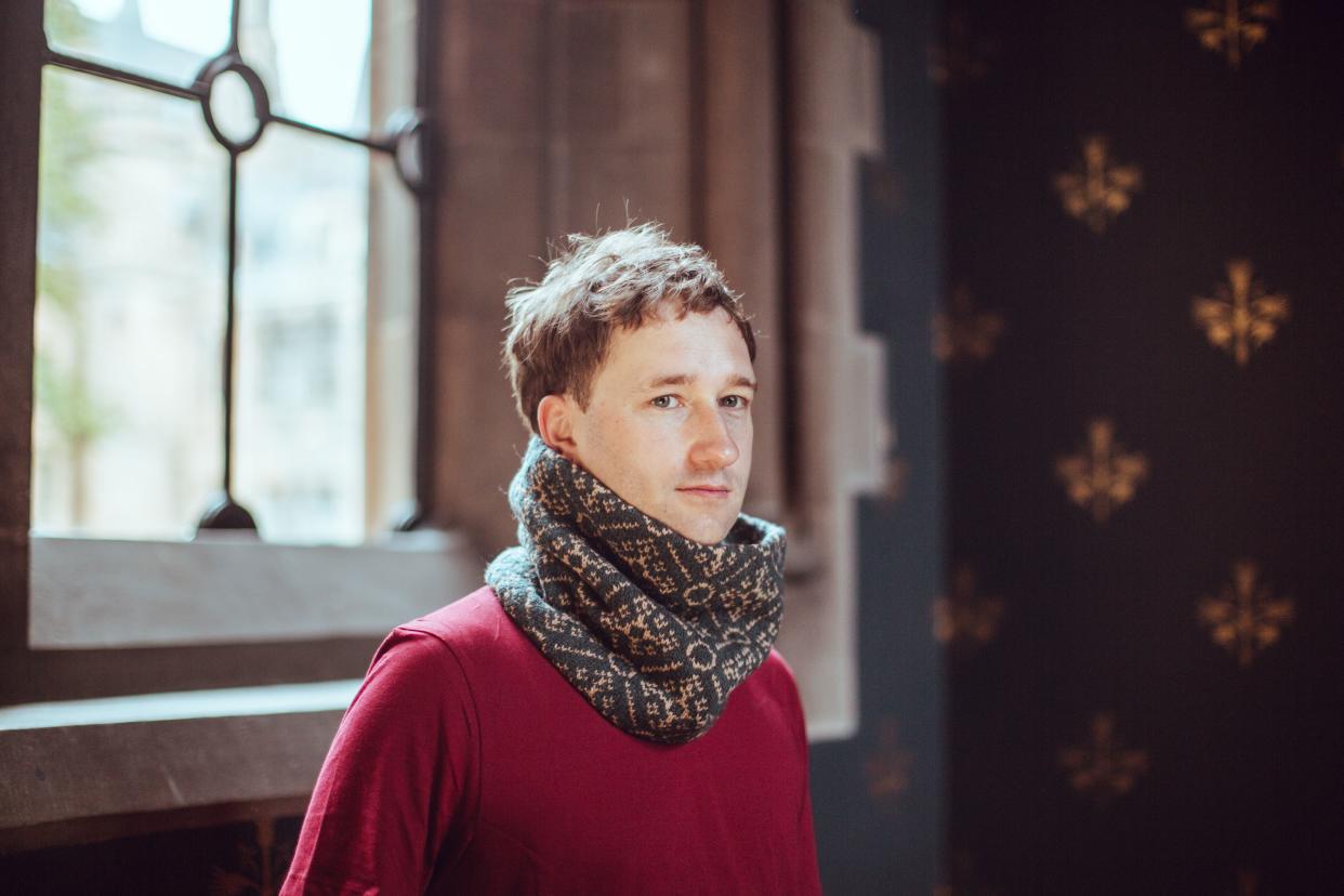 A man models a scarf based on one of the designs (University of Glasgow/PA)