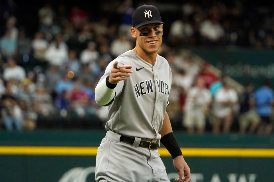 New York Yankees' Aaron Judge points to fans during warm ups before the second baseball game of a doubleheader against the Texas Rangers in Arlington, Texas, Tuesday, Oct. 4, 2022.