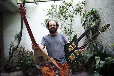 Argentine luthier Ezequiel Galasso shows a skate guitar and a double neck one, both made by him, at his workshop in Buenos Aires October 17, 2014. REUTERS/Marcos Brindicci