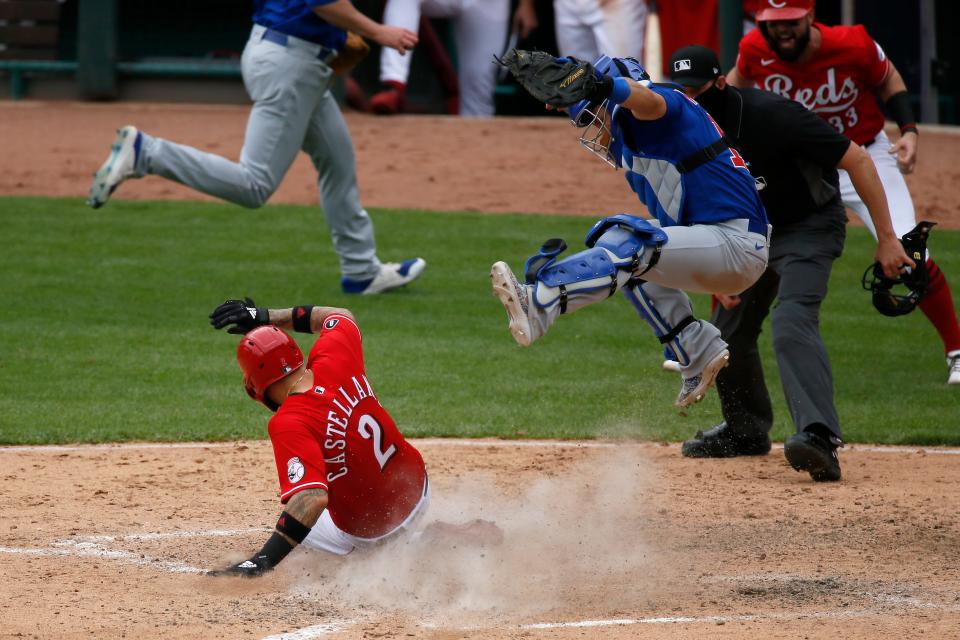 Reds right fielder Nick Castellanos beats a play at the plate to score on a two-run RBI single by shortstop Eugenio Suarez in the sixth inning.