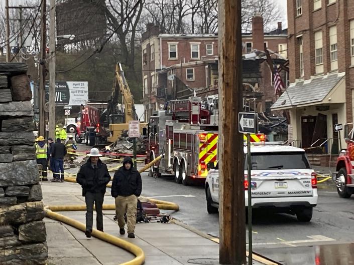 Emergency personnel and heavy equipment work at the site of a deadly explosion at a chocolate factory in West Reading, Pa.,, Saturday, March 25, 2023. (AP Photo/Michael Rubinkam)