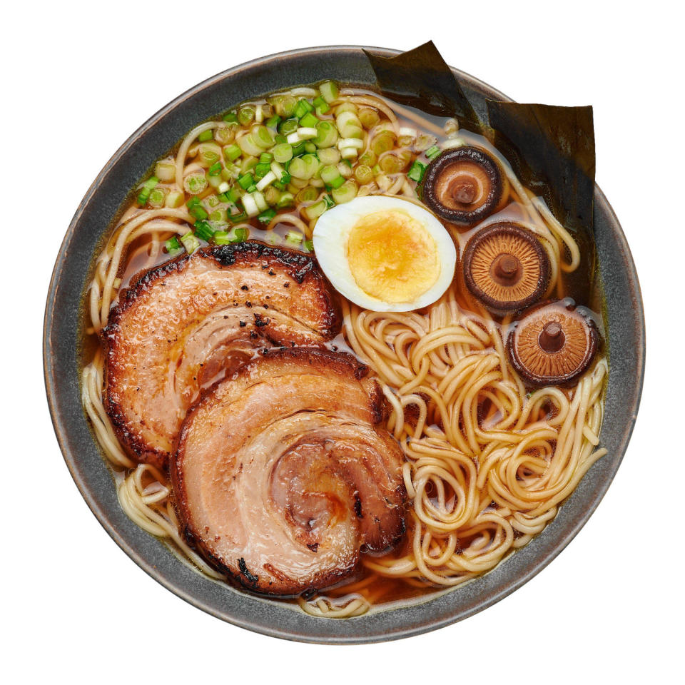 A Shoyu Ramen in gray bowl isolated on white. Japanese cuisine meat noodle soup with chashu pork. (Andrei Kravtsov / Alamy Stock Photo)