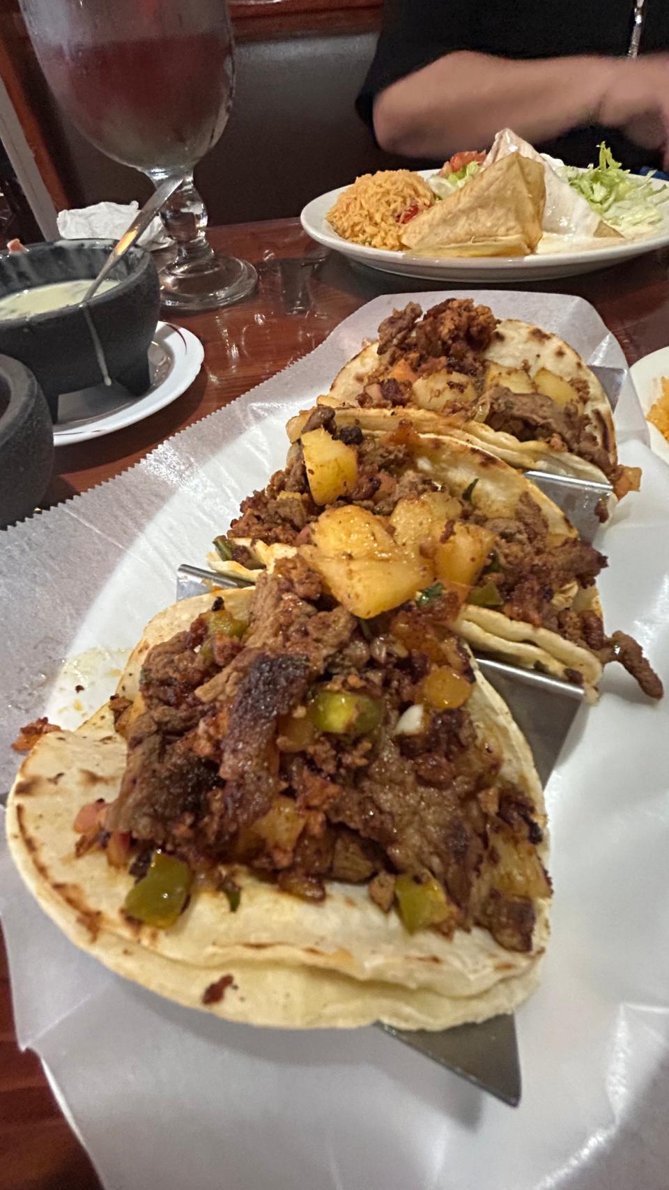 Mexican street tacos with steak, pineapple, chorizo, pico de gallo and potatoes on a corn tortilla are one of 12 street taco options at Tito's.