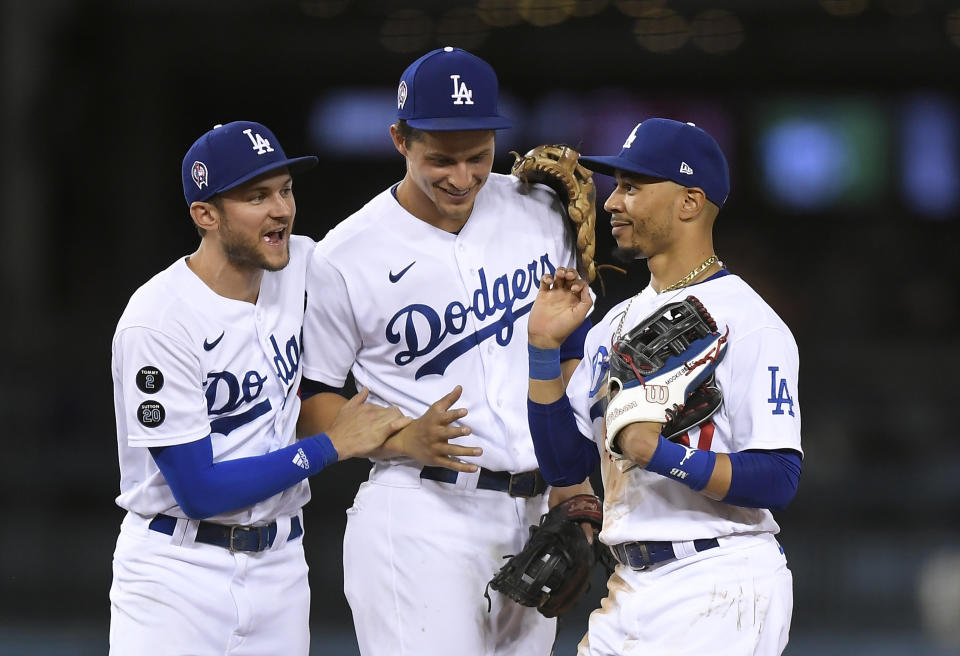 LOS ANGELES, CA - SEPTEMBER 11: Mookie Betts #50 of the Los Angeles Dodgers celebrate with Trea Turner #6 and Corey Seager #5 after defeating the San Diego Padres 5-4 at Dodger Stadium on September 11, 2021 in Los Angeles, California. (Photo by Kevork Djansezian/Getty Images)