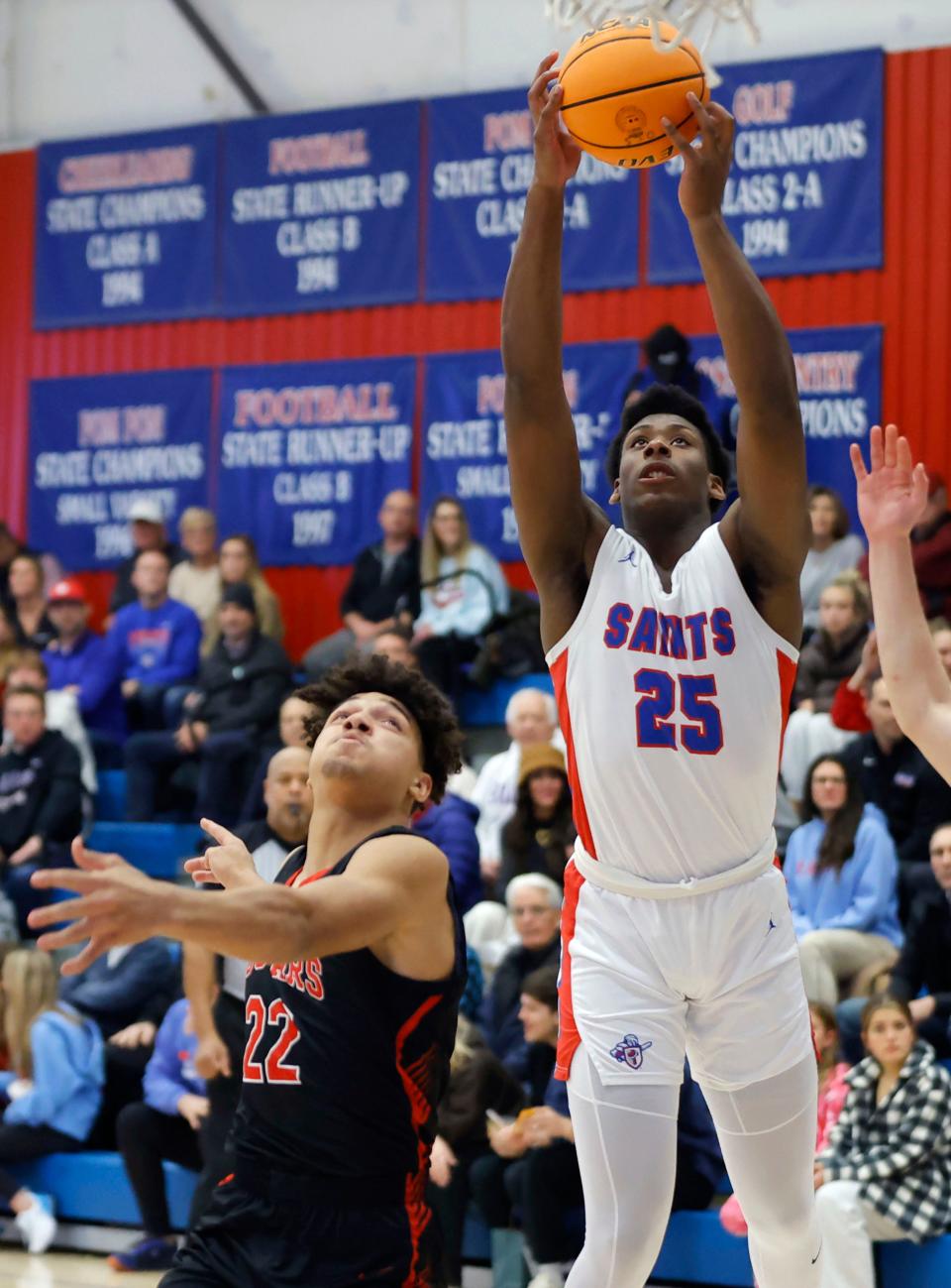 Oklahoma Christian School's Luke Gray grabs a rebound over North Rock Creek's Caleb Hawkins during a boys high school basketball game between North Rock Creek and Oklahoma Christian School in Edmond, Okla., Tuesday, Jan. 9, 2024.