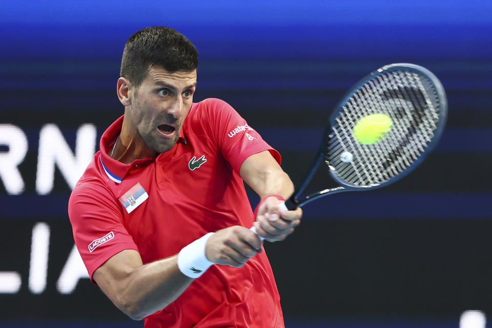 Novak Djokovic of Serbia hits a return shot to Alex de Minaur of Australia during the United Cup tennis tournament in Perth, Australia, Wednesday, Jan. 3, 2024. (AP Photo/Trevor Collens)