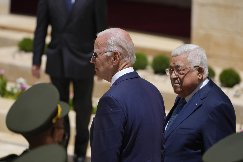 U.S. President Joe Biden and Palestinian President Mahmoud Abbas review the guard of honor during a welcoming ceremony prior to their meeting at the West Bank town of Bethlehem, Friday, July 15, 2022. (AP Photo/Majdi Mohammed)