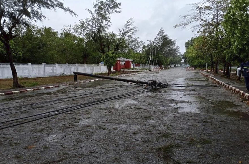 In this photo provided by Myanmar Military True News Information Team on Sunday, May 14, 2023, a lamppost damaged by Cyclone Mocha lines on a street in Kyauk Phyu township, Rakhine State. (Military True News Information Team via AP)