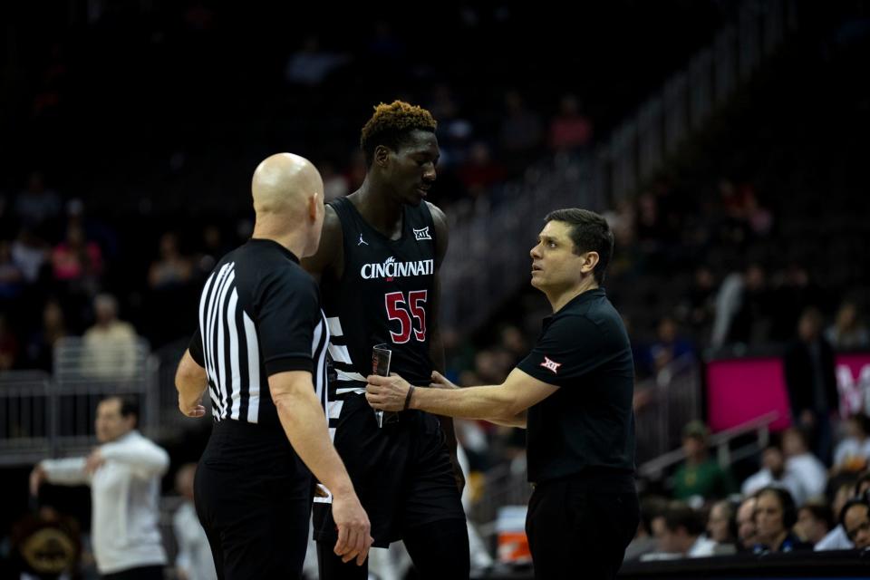 Cincinnati Bearcats forward Aziz Bandaogo (55) speaks with Cincinnati Bearcats head coach Wes Miller after being called for a foul in the second half of the Big 12 Conference tournament. UC played Bandaogo last season in the NIT quarterfinals when he was with Utah Valley University.