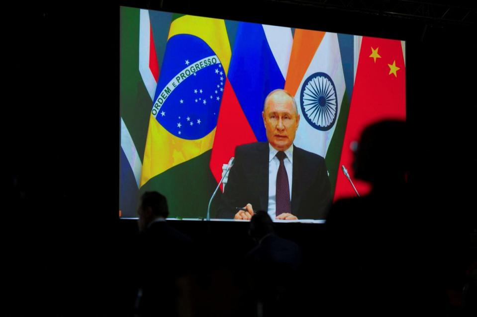 Russian president Vladimir Putin speaks via video link during a press conference (Reuters)