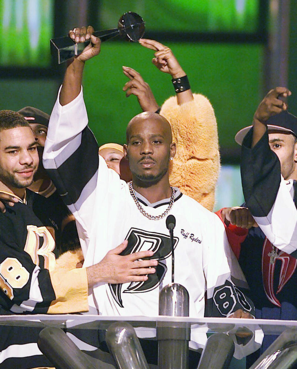 FILE - DMX, center, accepts the R&B Album Artist of the Year during the 1999 Billboard Music Awards in Las Vegas, on Dec. 8, 1999. The family of rapper DMX says he has died at age 50 after a career in which he delivered iconic hip-hop songs such as “Ruff Ryders’ Anthem." A statement from the family says the Grammy-nominated rapper died at a hospital in White Plains, New York, "with his family by his side after being placed on life support for the past few days. He was rushed to a New York hospital from his home April 2. (AP Photo/Laura Rauch, File)