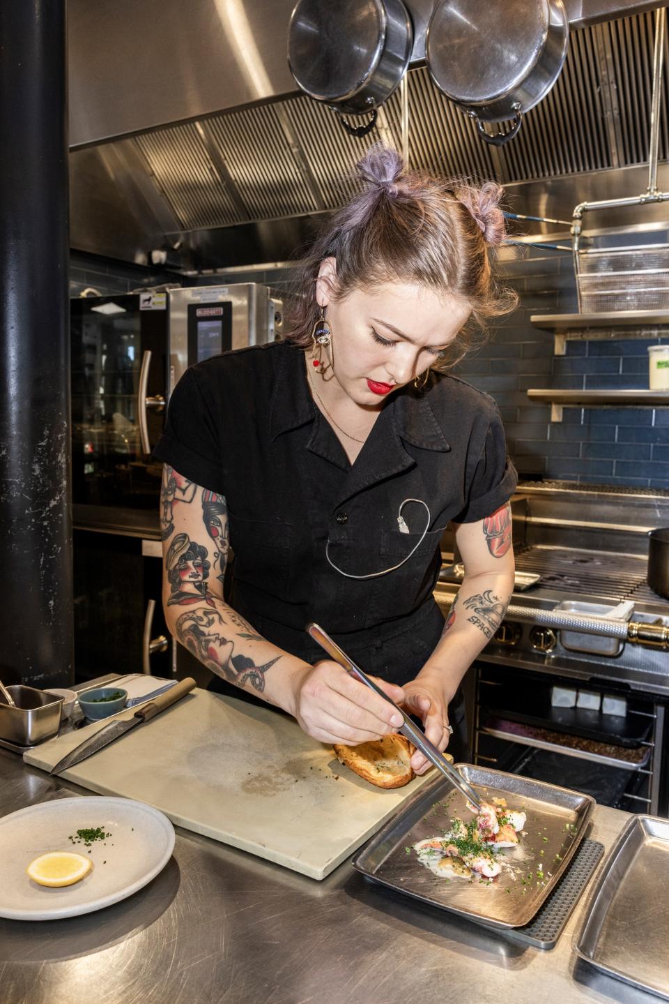 Chef de cuisine Hannah Ryder plates a lobster roll in a buttery, croissant style bun at Twelve.