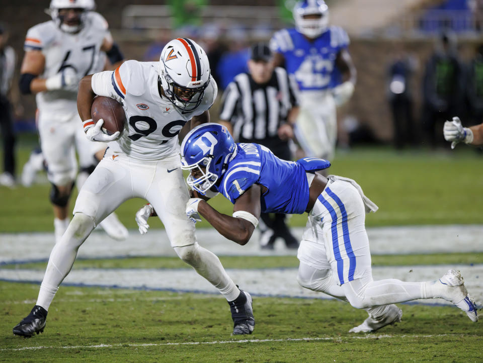 Virginia's Keytaon Thompson (99) is hit by Duke's Darius Joiner (1) during the second half of an NCAA college football game in Durham, N.C., Saturday, Oct. 1, 2022. (AP Photo/Ben McKeown)