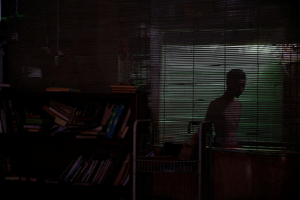 <p>A student is seen through blinds at a dormitory in Lirboyo Islamic boarding school in Kediri, Indonesia, May 18, 2018. (Photo: Beawiharta/Reuters) </p>