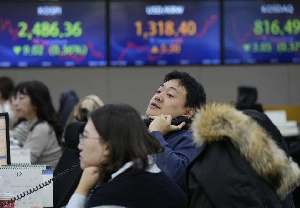 A currency watches monitors at the foreign exchange dealing room of the KEB Hana Bank headquarters in Seoul, South Korea, Thursday, Dec. 7, 2023. Shares fell Thursday in Asia after a retreat on Wall Street as crude oil prices slipped on expectations that supply might outpace demand. (AP Photo/Ahn Young-joon)