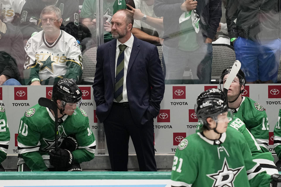 Dallas Stars head coach Peter DeBoer, center, watches play in the second overtime of Game 1 of an NHL hockey Stanley Cup first-round playoff series against the Minnesota Wild, Tuesday, April 18, 2023, in Dallas. (AP Photo/Tony Gutierrez)
