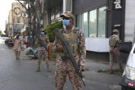 Soldiers stand alert outside a restricted area that is sealed off to control the spread of the coronavirus, in Karachi, Pakistan, Friday, June 19, 2020. (AP Photo/Fareed Khan)