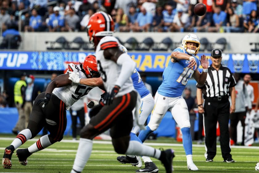 INGLEWOOD, CA - OCTOBER 10, 2021: Los Angeles Chargers quarterback Justin Herbert (10) passes own field against the Cleveland Browns at SoFi Stadium on October 10, 2021 in Inglewood, California. He threw for 398 yards and 4 touchdowns in the Chargers 47-42 win.(Gina Ferazzi / Los Angeles Times)