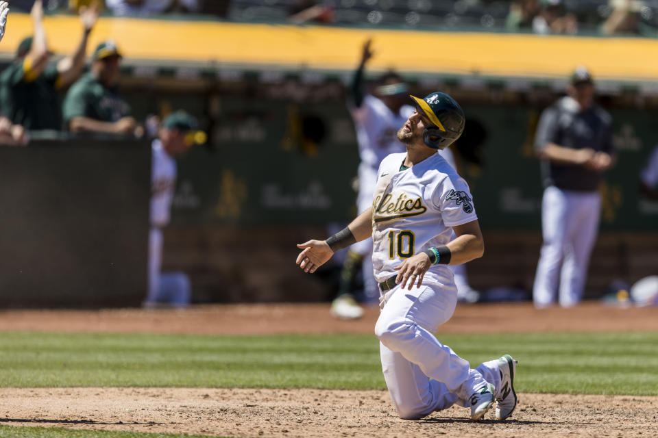 Oakland Athletics' Chad Pinder reacts after scoring against the Houston Astros during the seventh inning of a baseball game in Oakland, Calif., Wednesday, June 1, 2022. (AP Photo/John Hefti)