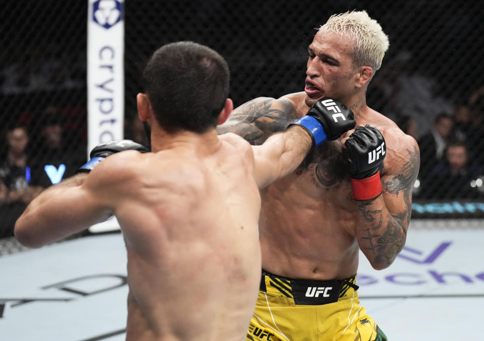 ABU DHABI, UNITED ARAB EMIRATES - OCTOBER 22: (L-R) Islam Makhachev of Russia punches Charles Oliveira of Brazil in their UFC lightweight championship fight during the UFC 280 event at Etihad Arena on October 22, 2022 in Abu Dhabi, United Arab Emirates. (Photo by Chris Unger/Zuffa LLC)