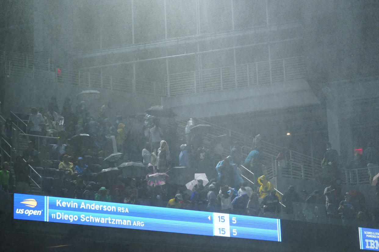 Sep 1, 2021; Flushing, NY, USA; Rain falls into Louis Armstrong Stadium from the openings along the side as Diego Schwartzman of Argentina faces Kevin Anderson of South Africa on day three of the 2021 U.S. Open tennis tournament at USTA Billie Jean King National Tennis Center. Mandatory Credit: Danielle Parhizkaran-USA TODAY Sports