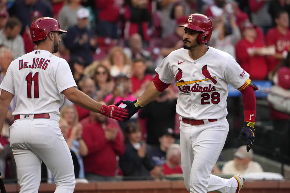 St. Louis Cardinals' Nolan Arenado (28) is congratulated by teammate Paul DeJong (11) after hitting a solo home run during the second inning of a baseball game against the Milwaukee Brewers Tuesday, May 16, 2023, in St. Louis. (AP Photo/Jeff Roberson)