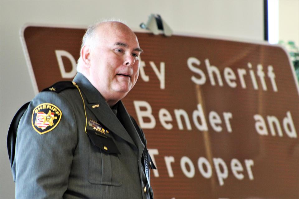Marion County Sheriff Matt Bayles pays tribute to local law enforcement officers Deputy Bill Bender and Trooper Randy Bender, who were killed in the line of duty, during a ceremony dedicating part of Ohio 309 in their honor on Friday, July 15, 2022.