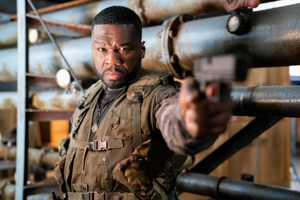 Curtis Jackson, aka 50 Cent, pointing a gun in a scene from in Expend4bles